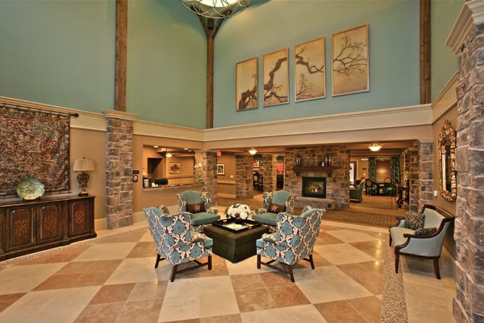 A beautifully decorated lobby with a comfortable seating area and elegant artwork on the walls.