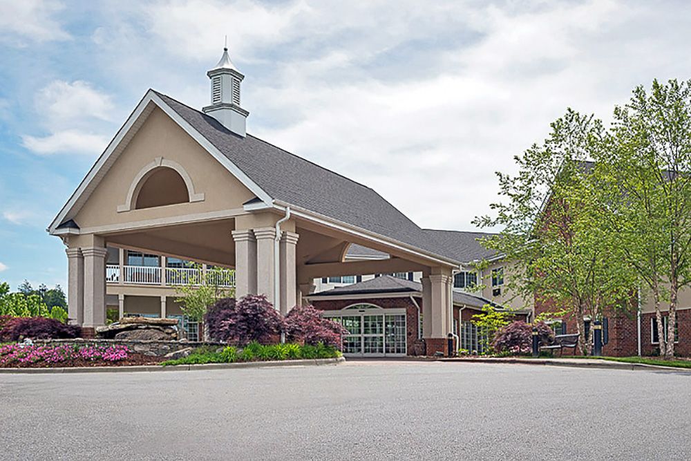 A welcoming building entrance with landscaped surroundings.