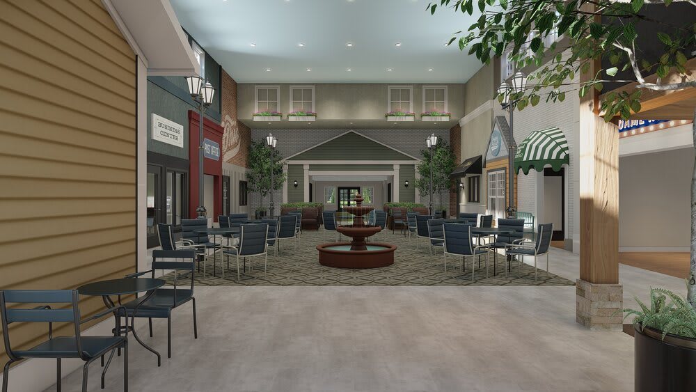 An indoor seating area with a central fountain, surrounded by tables and chairs, decorative lighting, and potted plants.