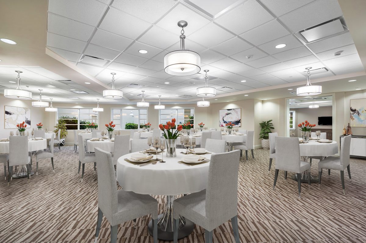 A well-decorated dining room with elegantly set tables and modern lighting.