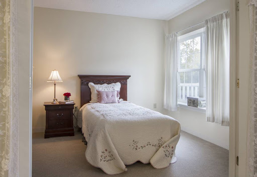 Cozy and inviting bedroom with a neatly made bed and natural light.