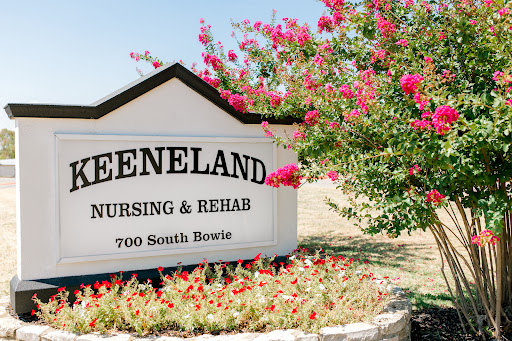 Keeneland Nursing & Rehab center, surrounded by vibrant flowers and greenery.