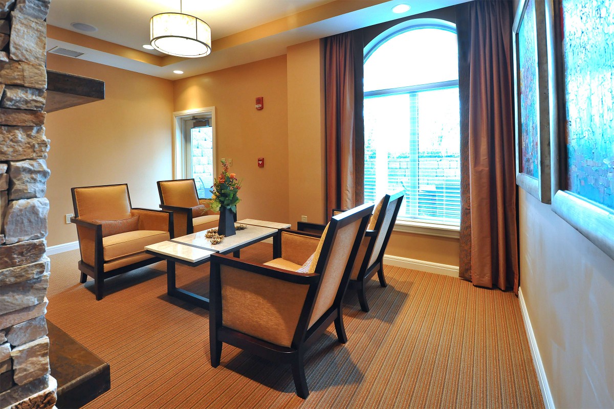 A cozy living room featuring comfortable seating and a large window providing ample natural light.