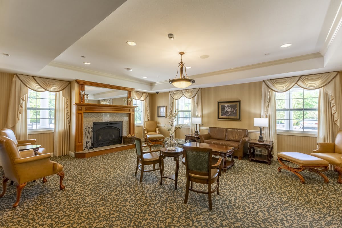 A cozy living room with classic furniture and a fireplace.