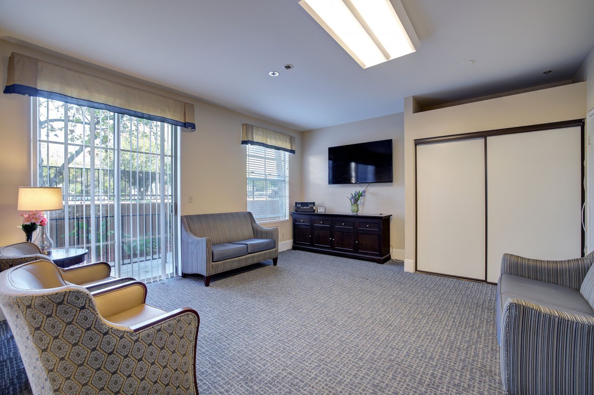 A bright and modern living room with comfortable seating and a flat-screen TV.
