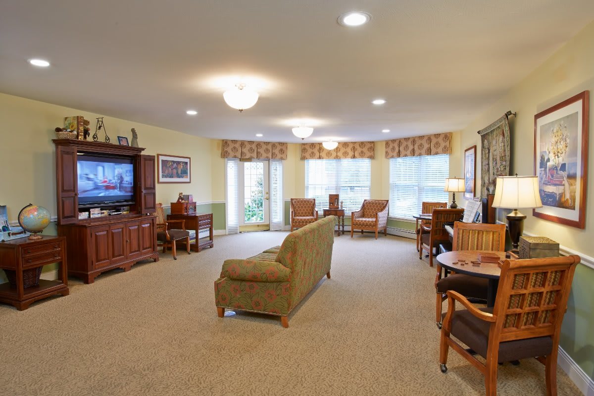 A spacious and well-decorated living room with comfortable seating and a television.