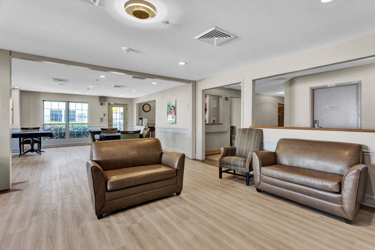 A cozy seating area with sofas and chairs in a well-lit room.