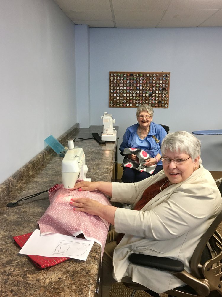 Two women enjoying a sewing session together.