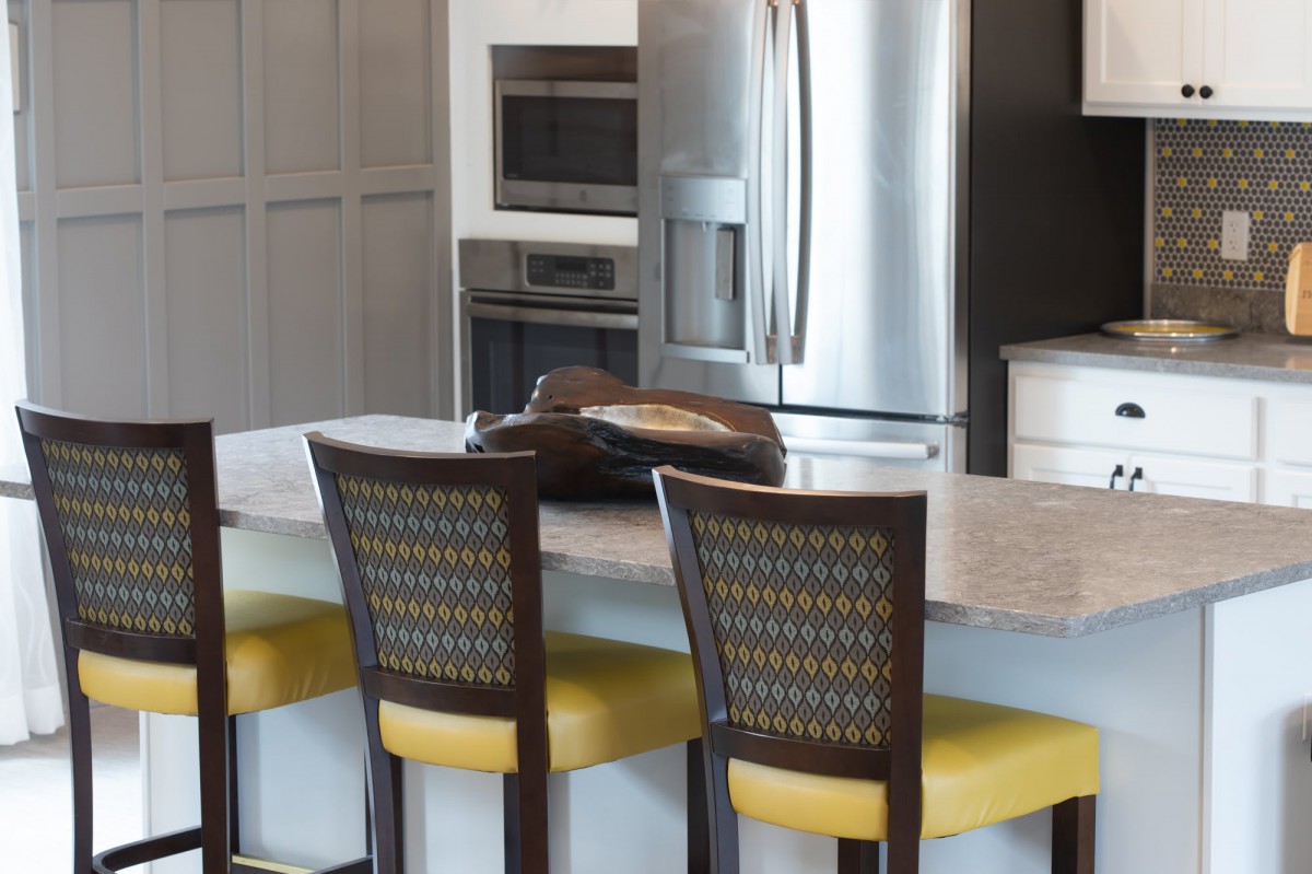 Modern kitchen with stainless steel appliances and a central island with seating.