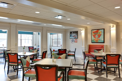 A cozy dining area featuring modern furniture and a bright, inviting atmosphere.