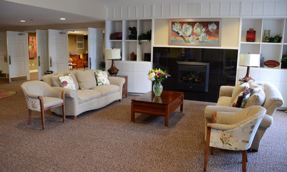 A well-decorated living room with comfortable seating and a fireplace.