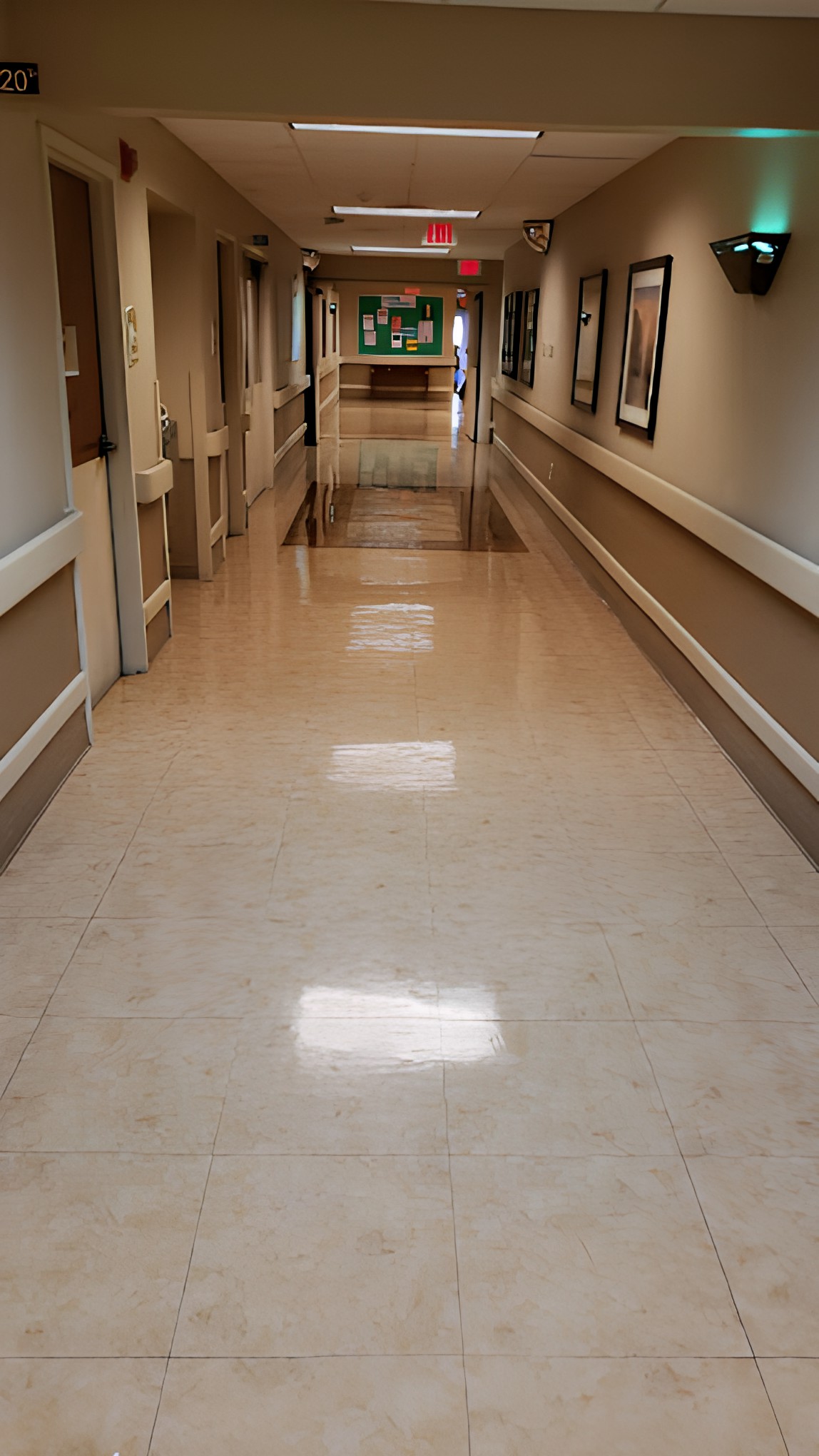 A clean and empty hospital corridor with shiny floors.