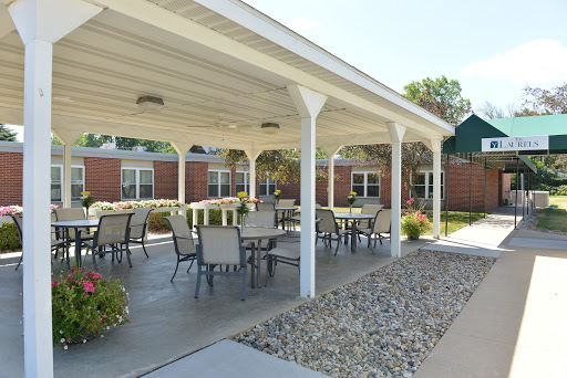 A serene outdoor patio area featuring tables and chairs, perfect for gatherings or relaxation.