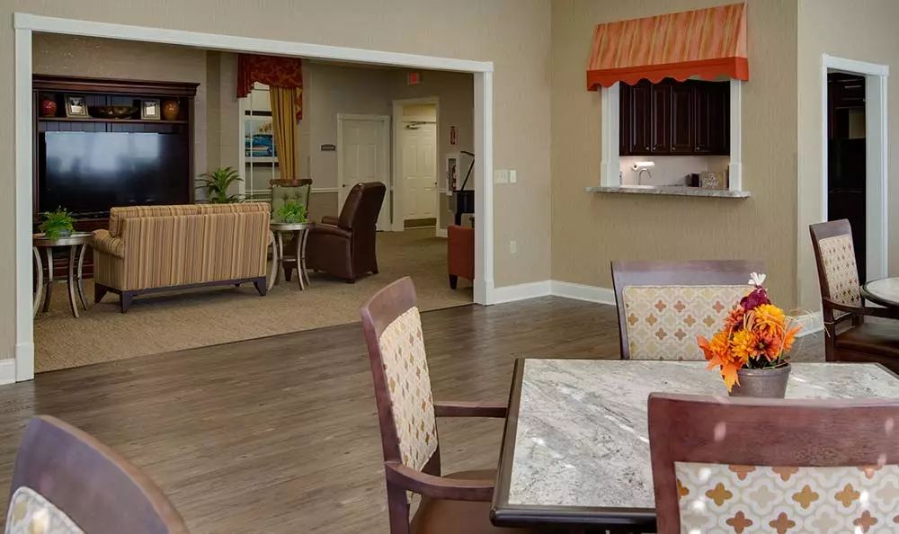 A cozy interior dining area with a view into the kitchen and living space.