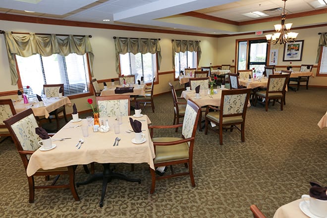 A neatly arranged dining room with tables set for guests.