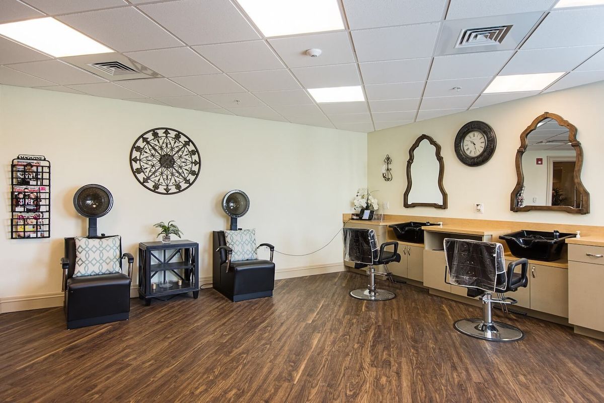 A modern hair salon interior featuring styling chairs and decorative wall elements.