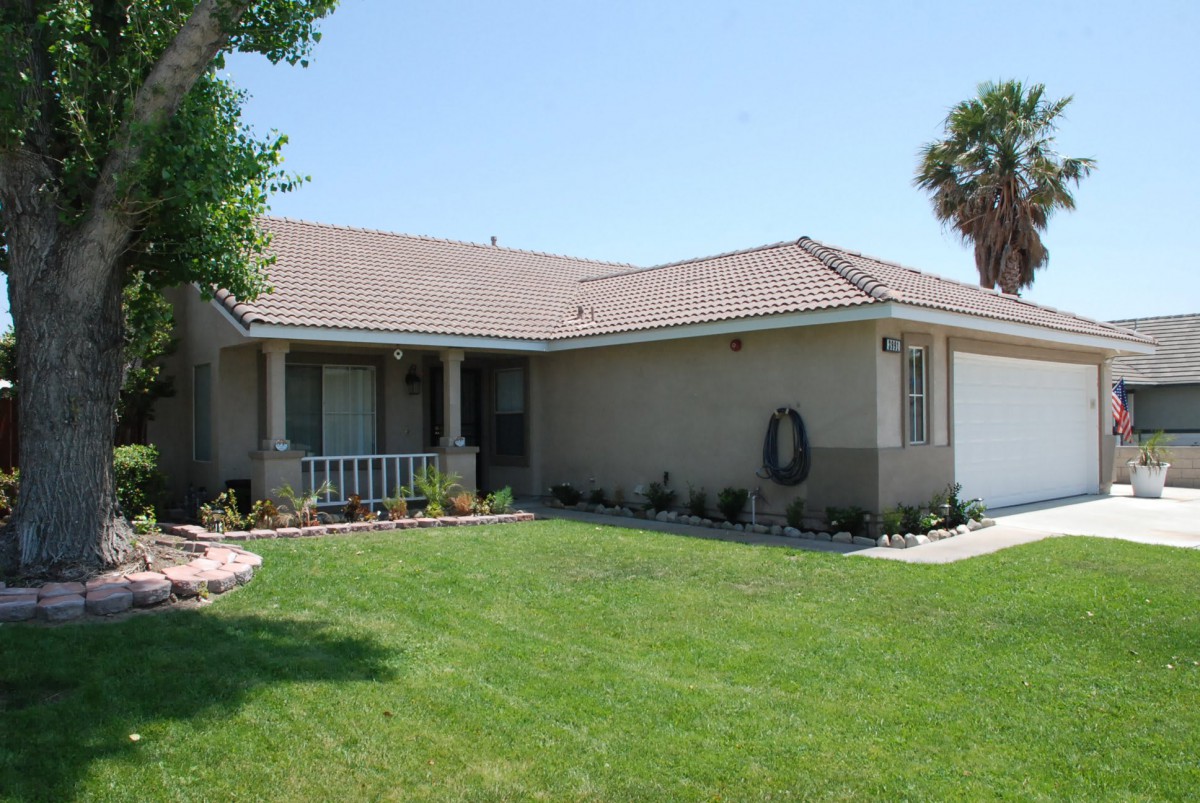 A suburban house with a well-maintained lawn and garden.