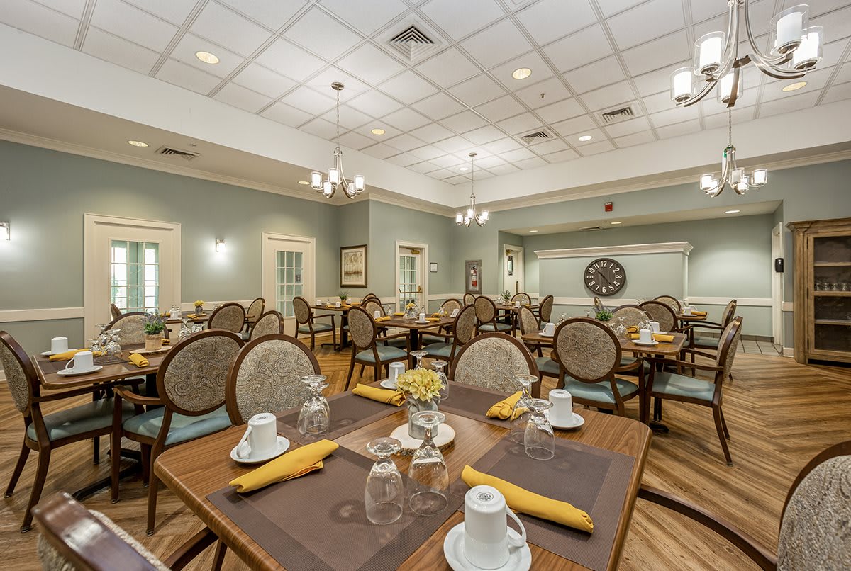 A spacious and elegantly decorated dining room with neatly arranged tables and chairs.
