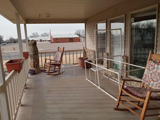 A peaceful porch with rocking chairs, perfect for relaxation in a rural setting.