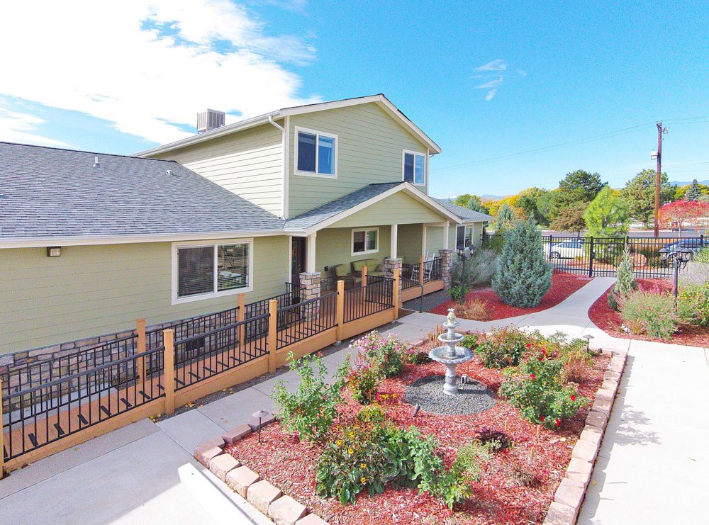 A well-maintained residential house with a landscaped garden and pathway.