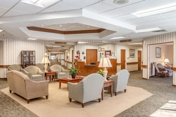 A spacious lobby area with comfortable seating and a reception desk.