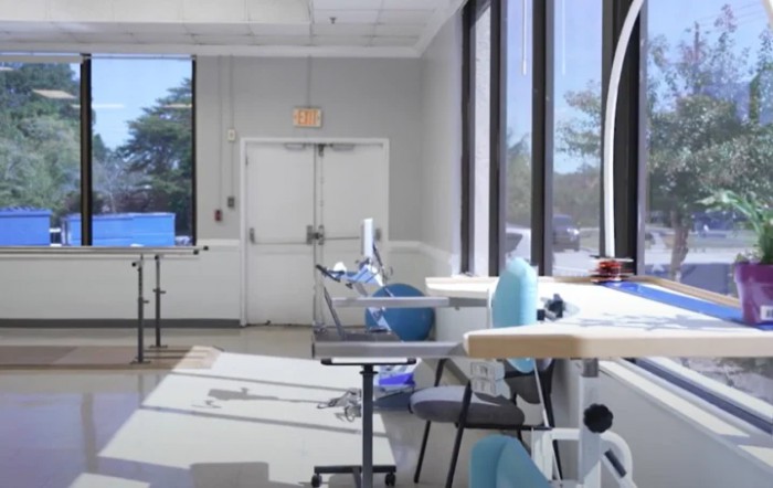 A bright dental office with multiple dentist chairs and large windows.