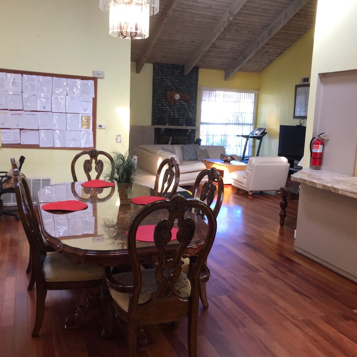 A cozy open-layout dining and living area with elegant wooden furniture.