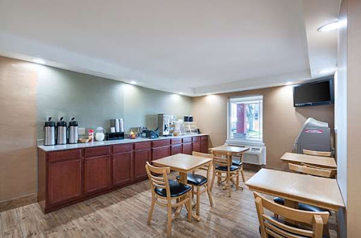 A cozy breakfast area featuring wooden furniture and a coffee station, perfect for casual dining.