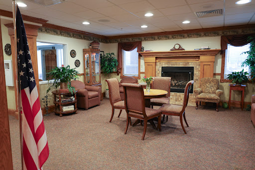 A cozy lounge area featuring comfortable seating and a fireplace.