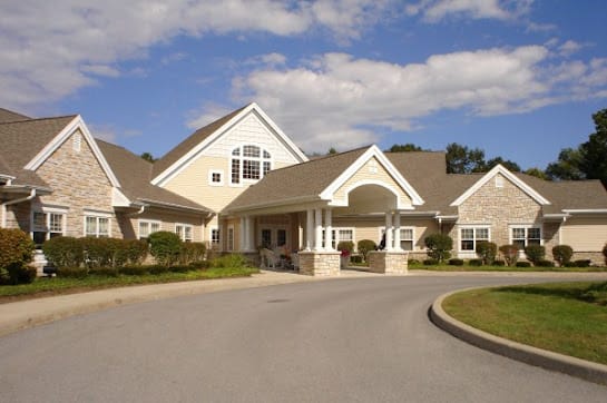 A large suburban house with a spacious driveway and a well-maintained entrance.