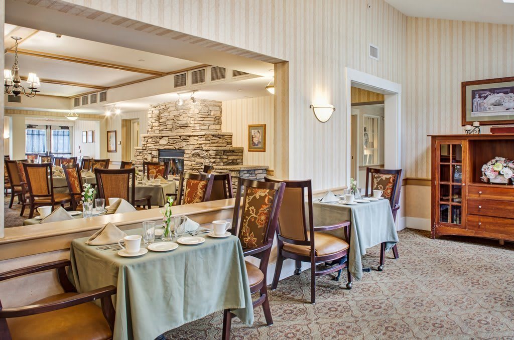 A cozy dining area with elegantly set tables and comfortable seating.