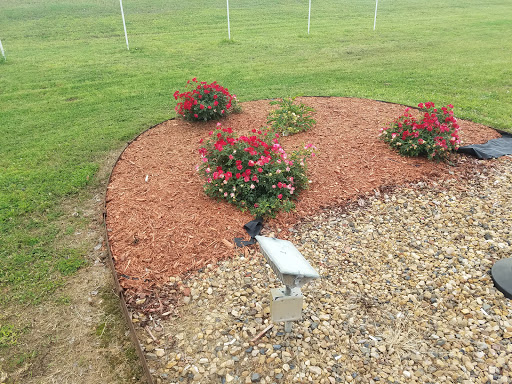 A beautifully landscaped garden featuring blooming flowers and mulch.