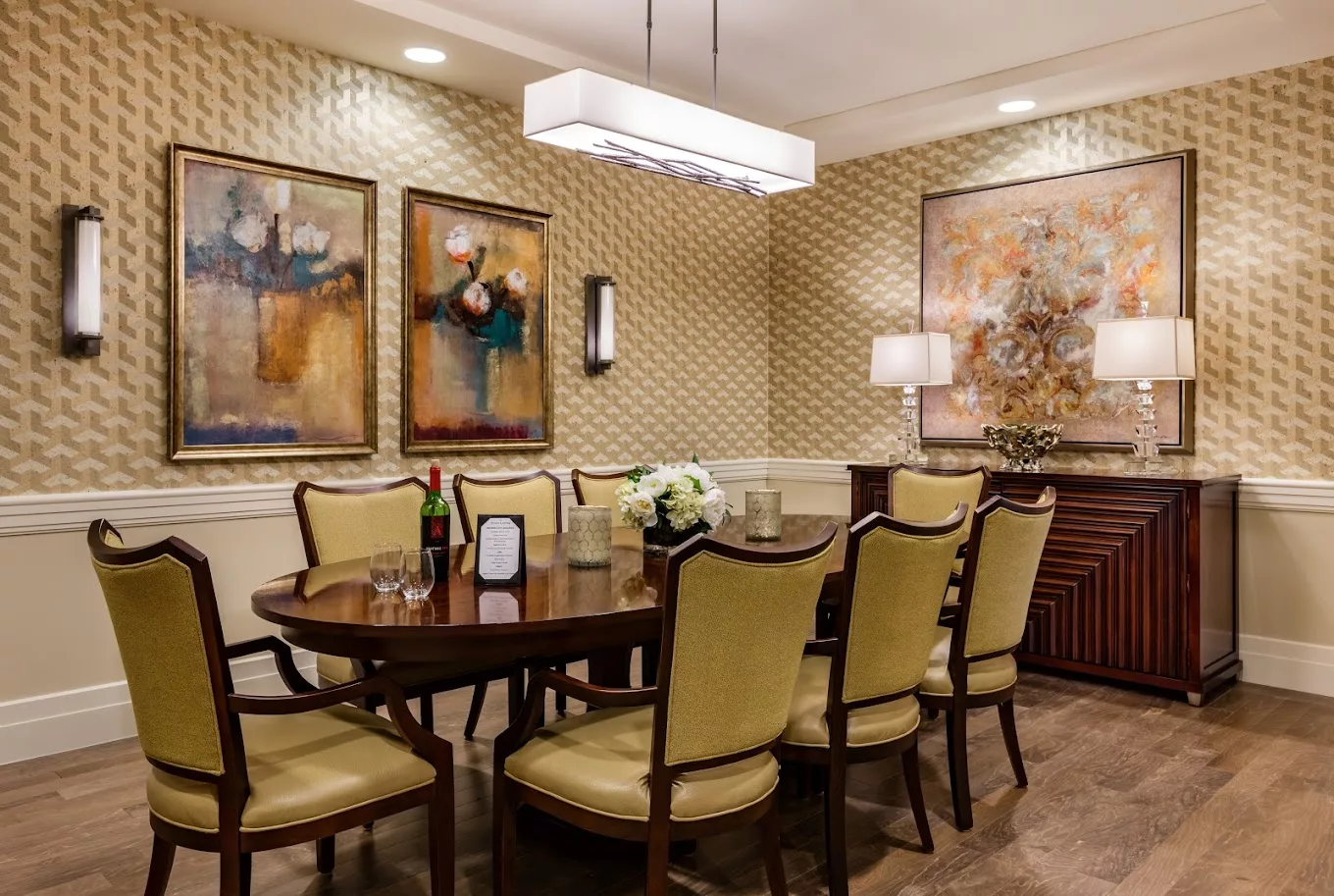 A well-decorated dining room featuring elegant furniture and artistic wall decor.