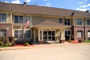 A suburban building with an American flag at the entrance.
