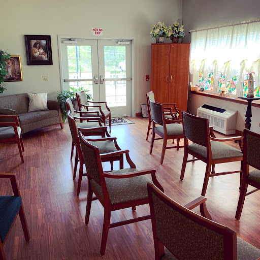 A cozy waiting room with comfortable chairs arranged in a circle, welcoming natural light filtering through the windows.