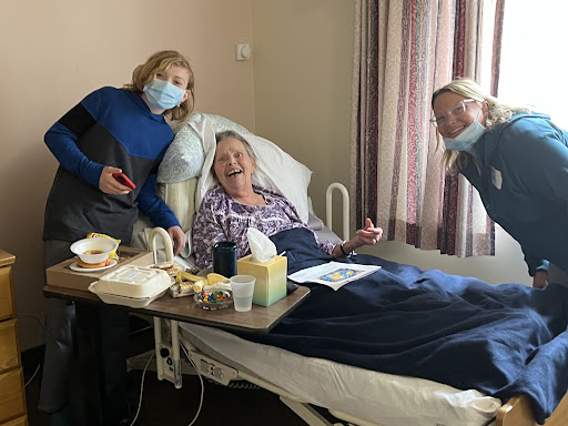 Visitors bring joy and companionship to a patient in a hospital room.