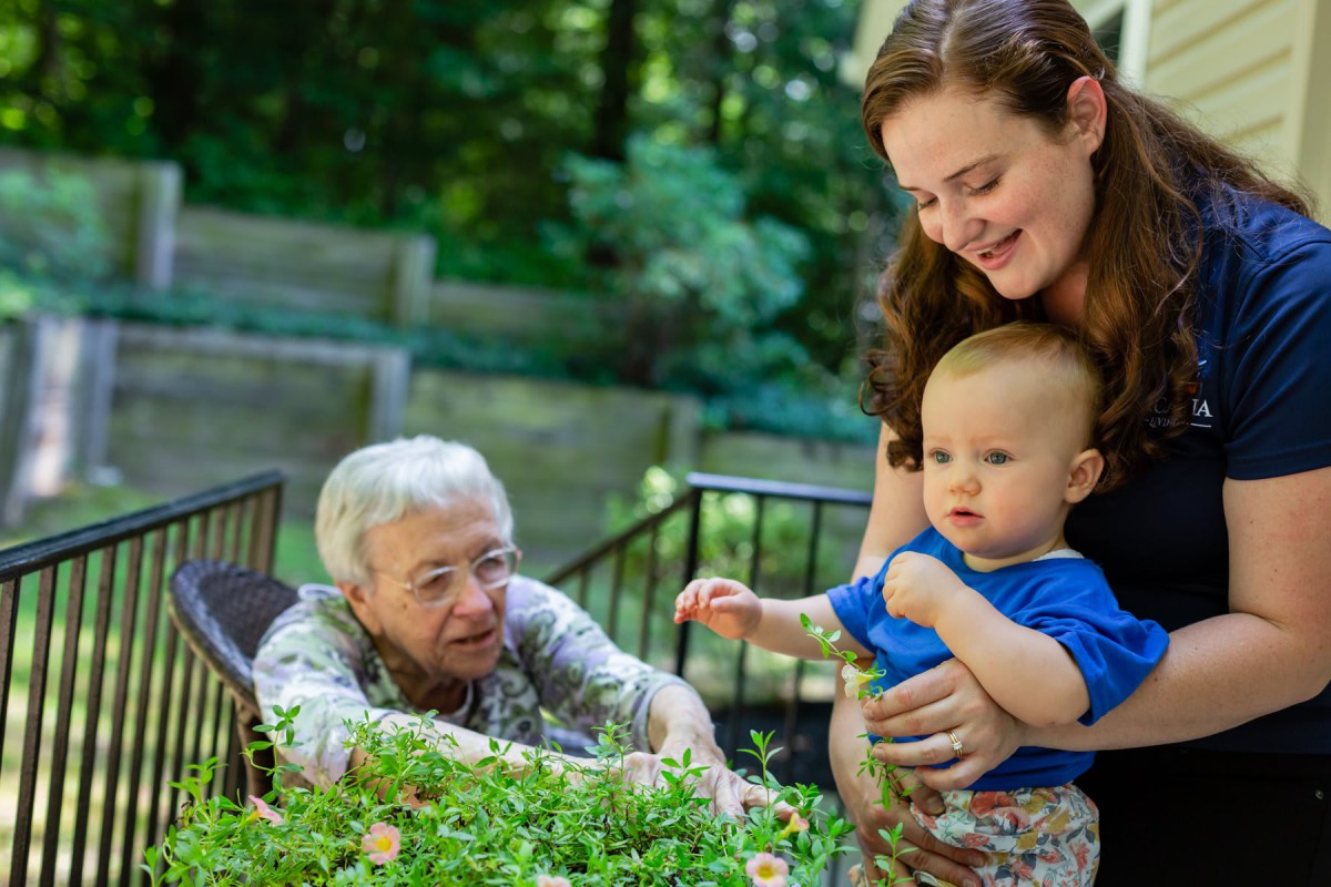 A multigenerational family enjoying time together in the garden.
