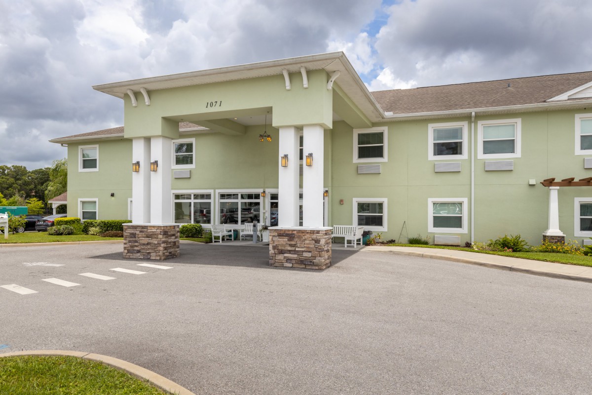 A modern hotel with a welcoming entrance and large columns.