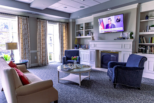 A cozy living room setting featuring comfortable seating, a television, and a decorative coffee table.