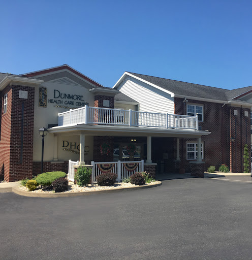 A sunny view of a two-story hotel with a welcoming entrance.