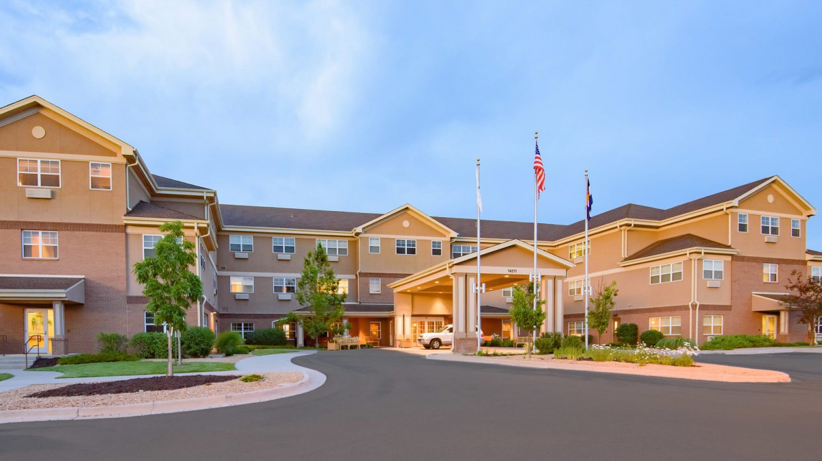 A hotel exterior with a welcoming entrance and flags displayed.