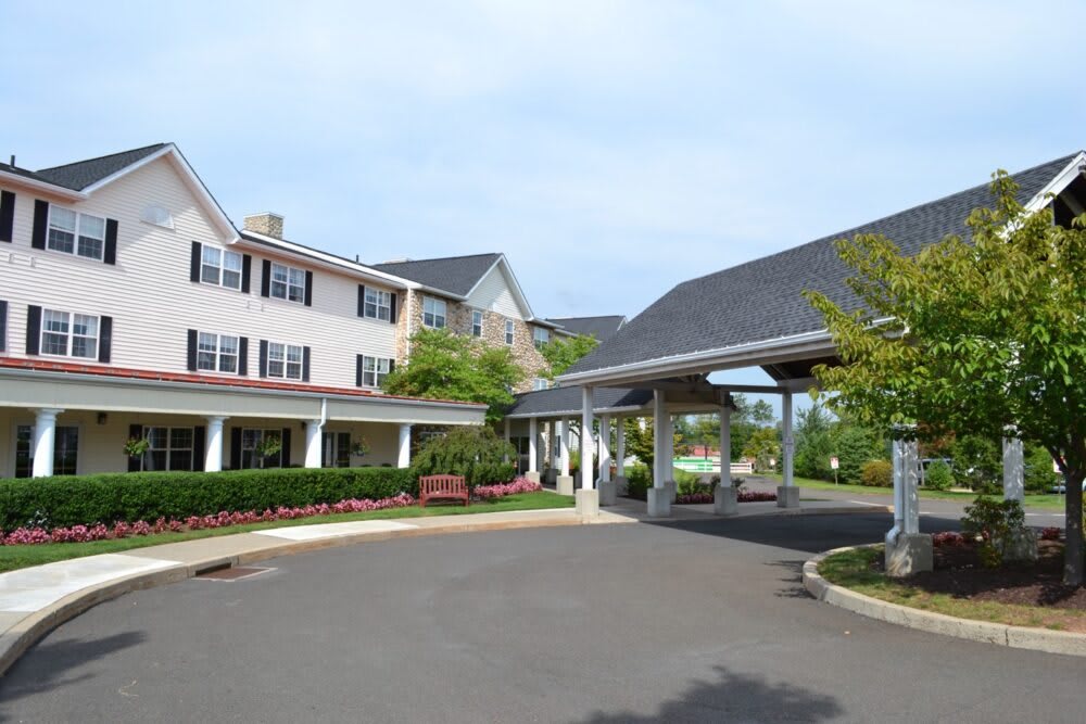 A large building with a covered entrance and well-maintained landscaping.