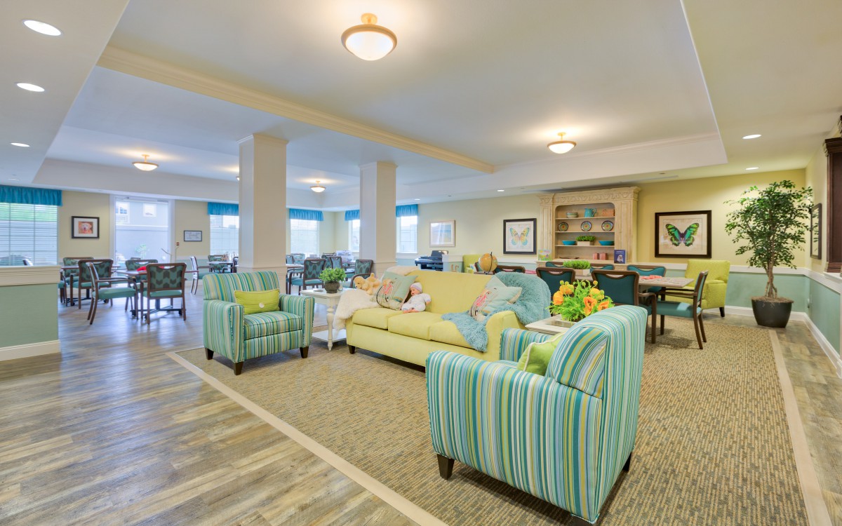 A bright and spacious living room with colorful furniture and modern decor.