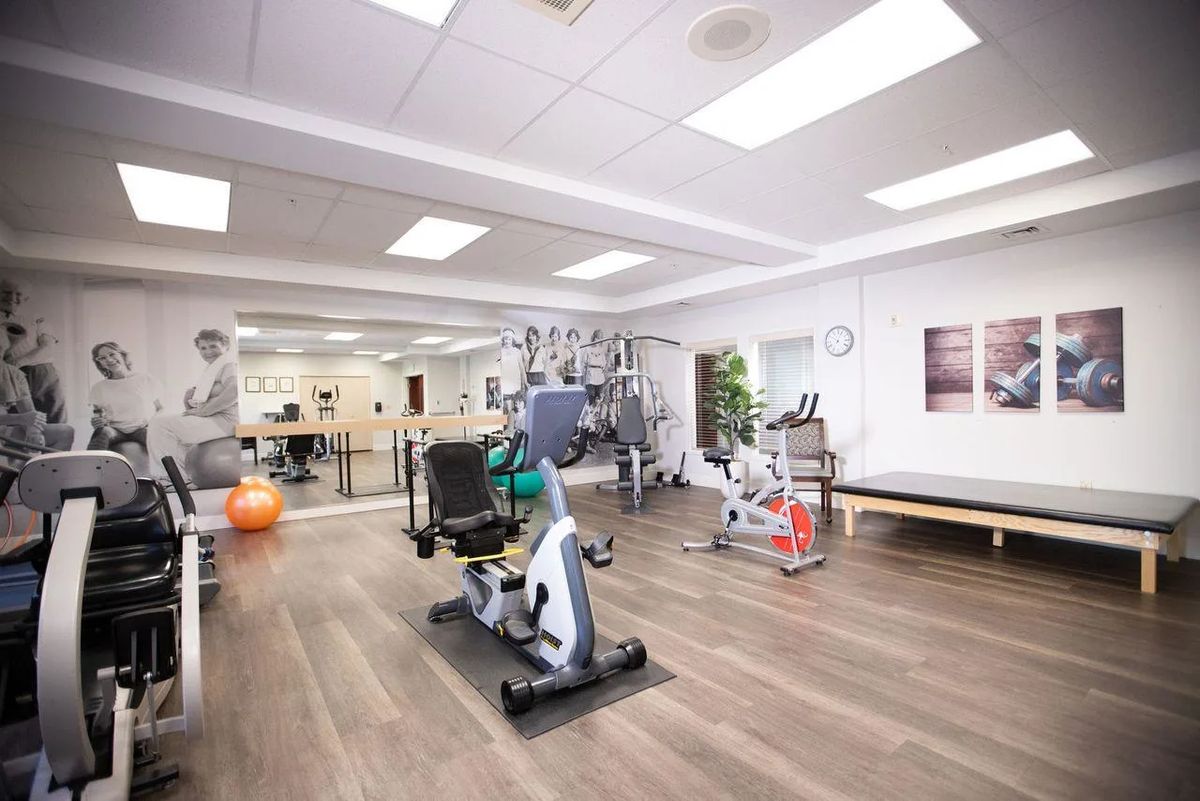 A modern gym with various fitness equipment and exercise machines.