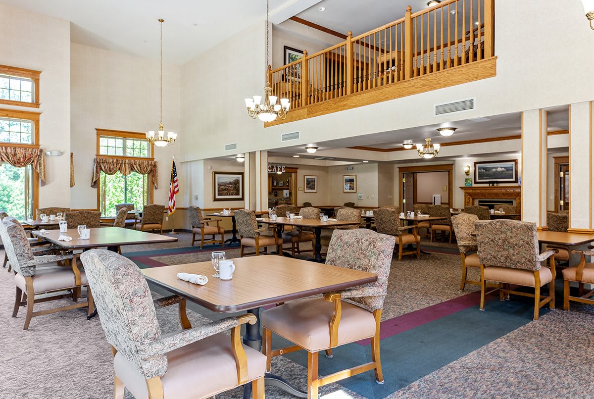 A spacious, well-lit dining area with a mezzanine and cozy seating arrangements.