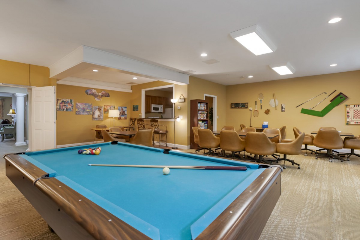 A cozy game room featuring a pool table and comfortable seating.