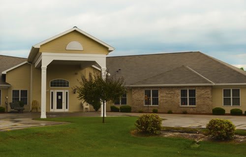 A suburban house with a large entrance and well-maintained lawn.