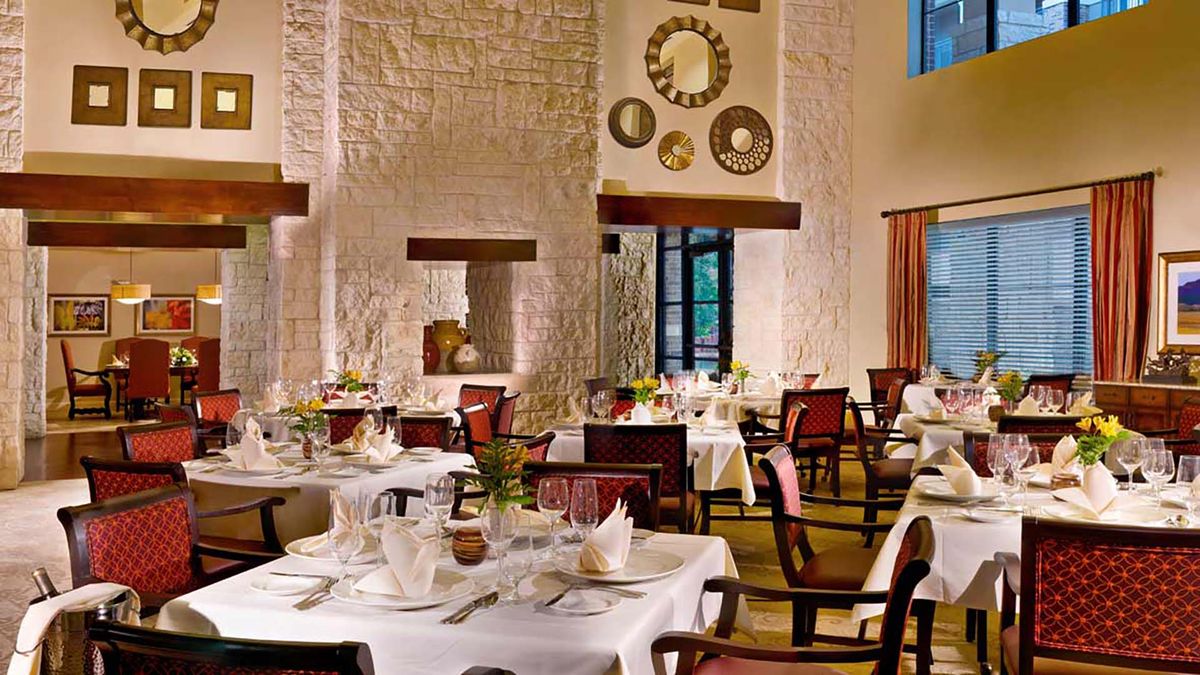 An elegant restaurant dining room with neatly arranged tables and stylish decor.