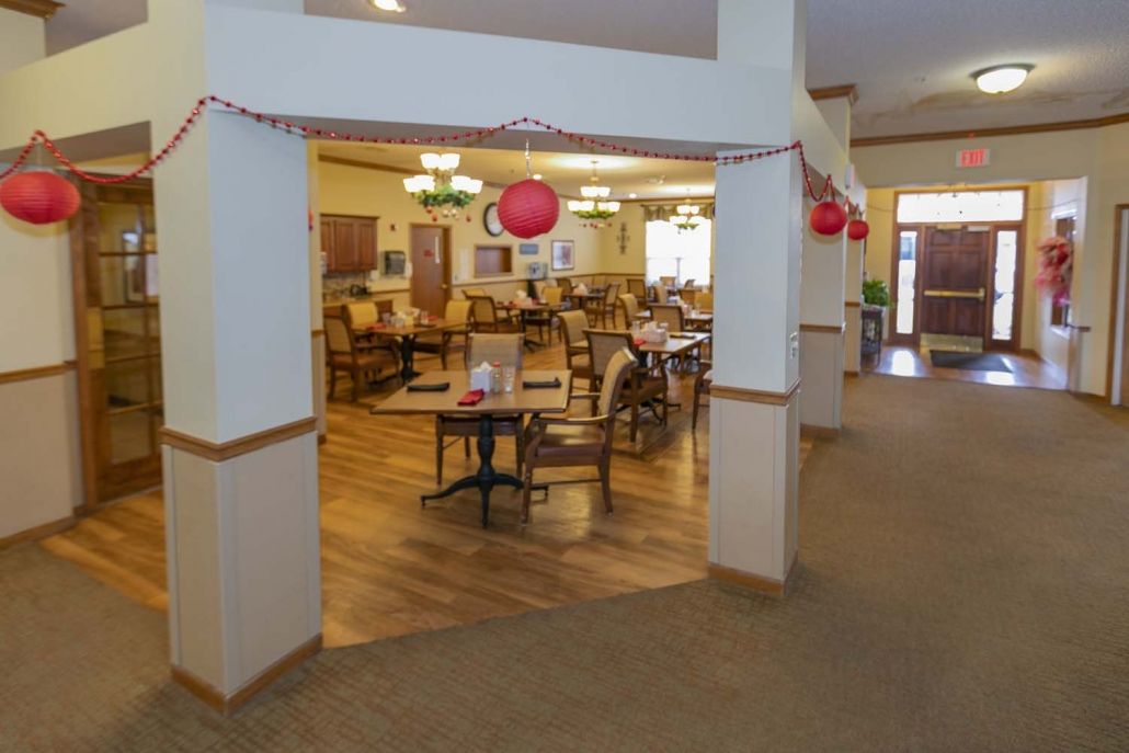A decorated dining area with tables and chairs in a community space.