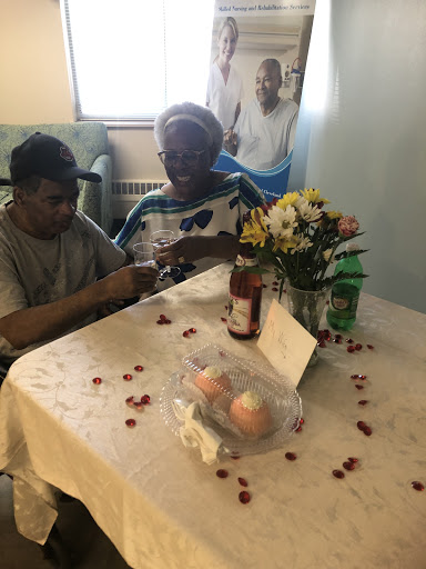 A heartwarming moment of connection between family members, surrounded by flowers and a cozy table setting.